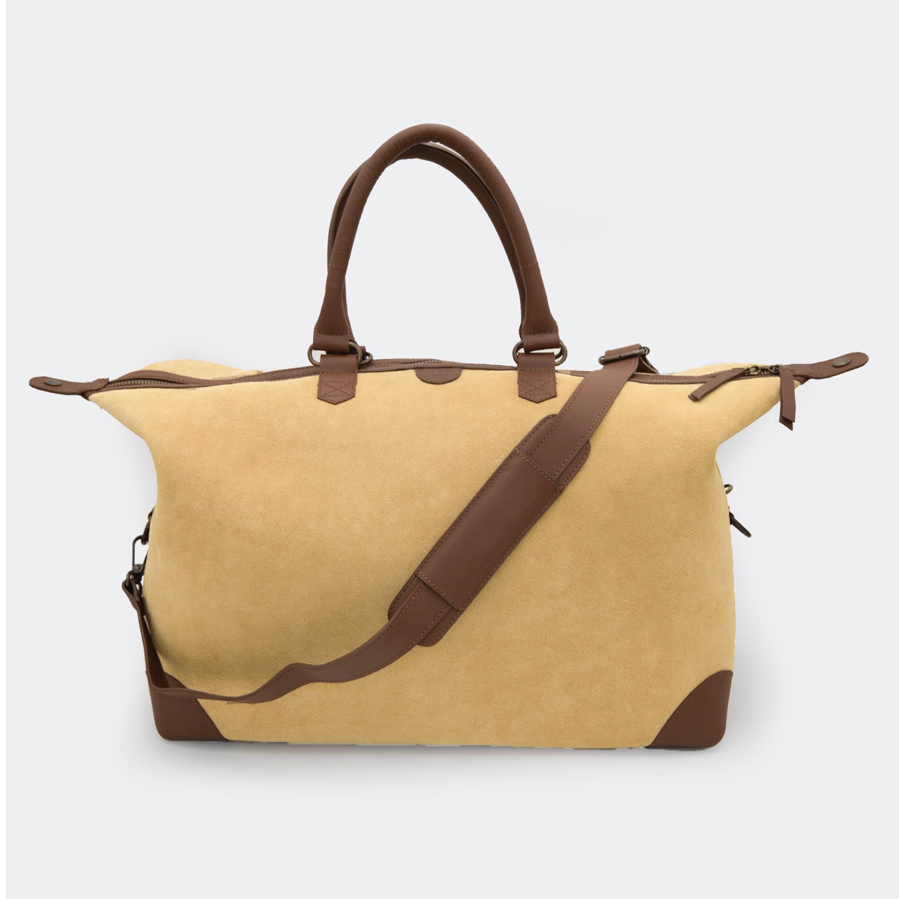 The Valise in tan leather, shown with its removable full-grain leather shoulder strap attached — designed for hands-free carry and versatile travel.