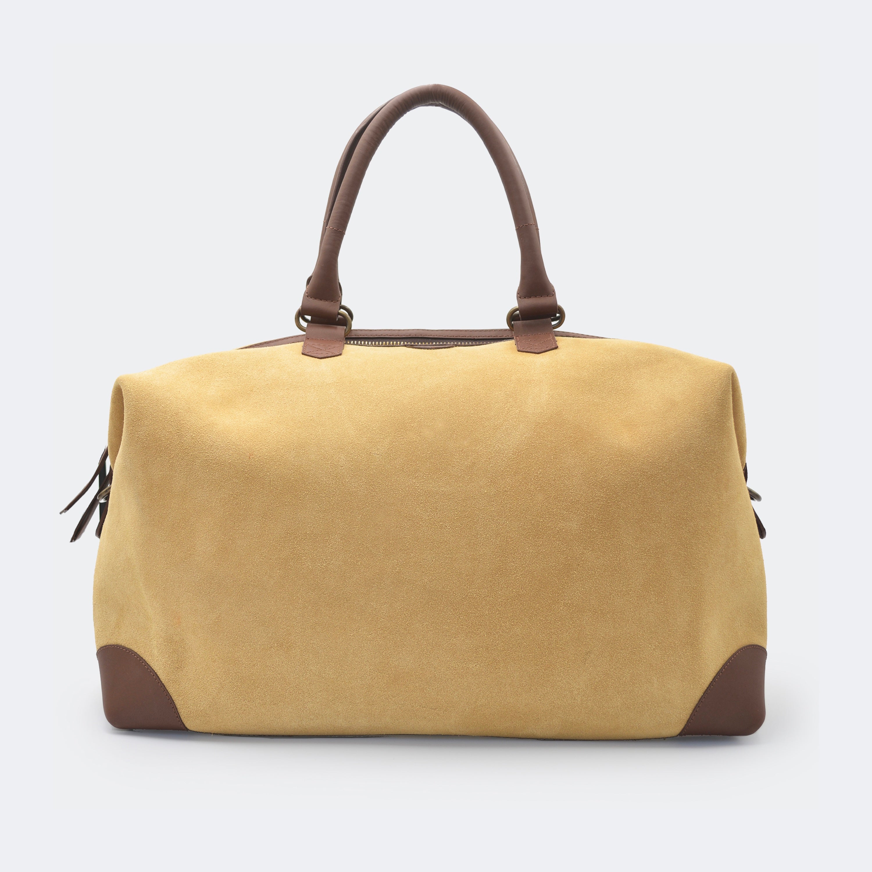 The Valise in tan leather, crafted from full-grain leather with structured sides and curved handles — a minimalist travel bag blending elegance and utility.