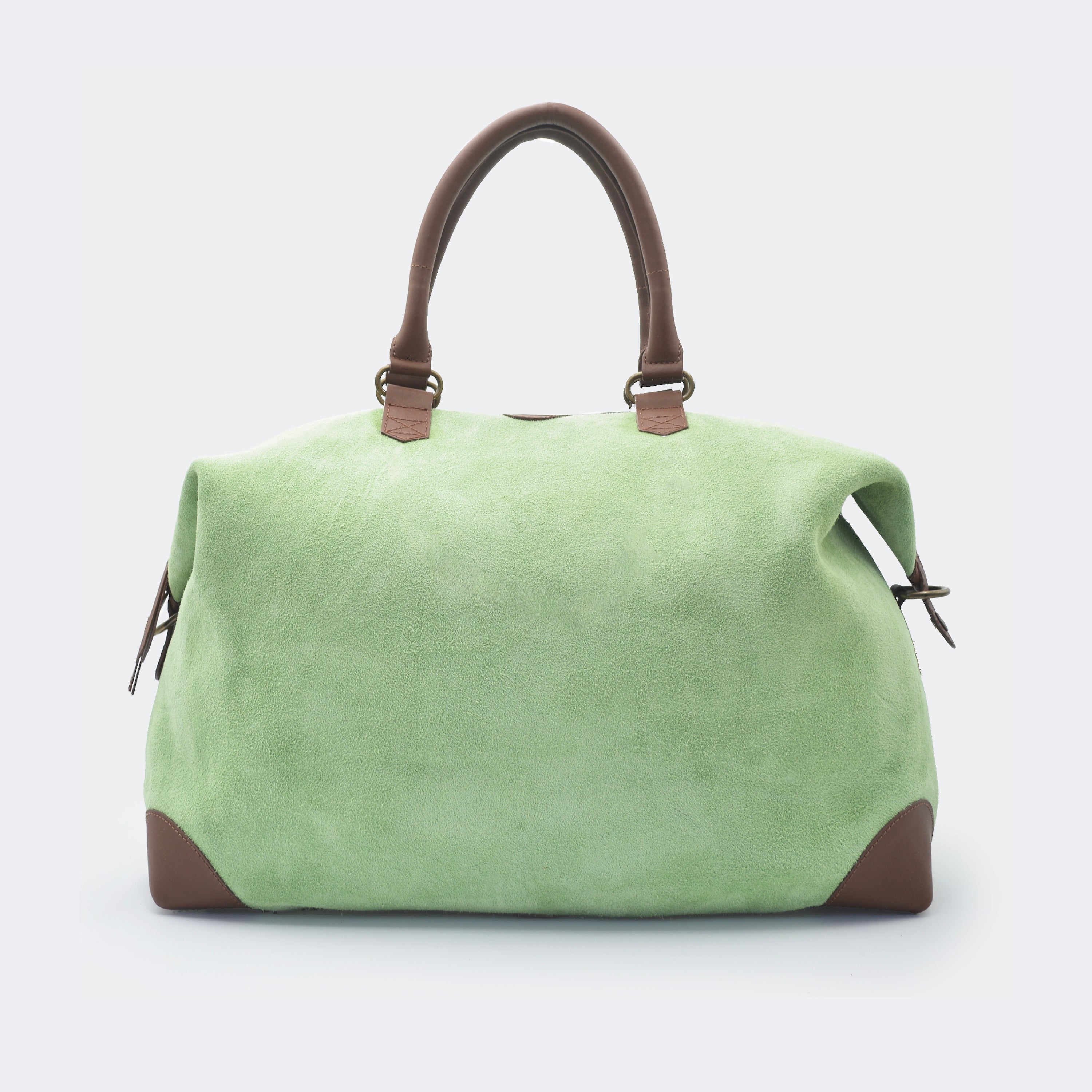 The Valise in mint green leather, crafted from full-grain leather with structured sides and curved handles — a minimalist travel bag blending elegance and utility.