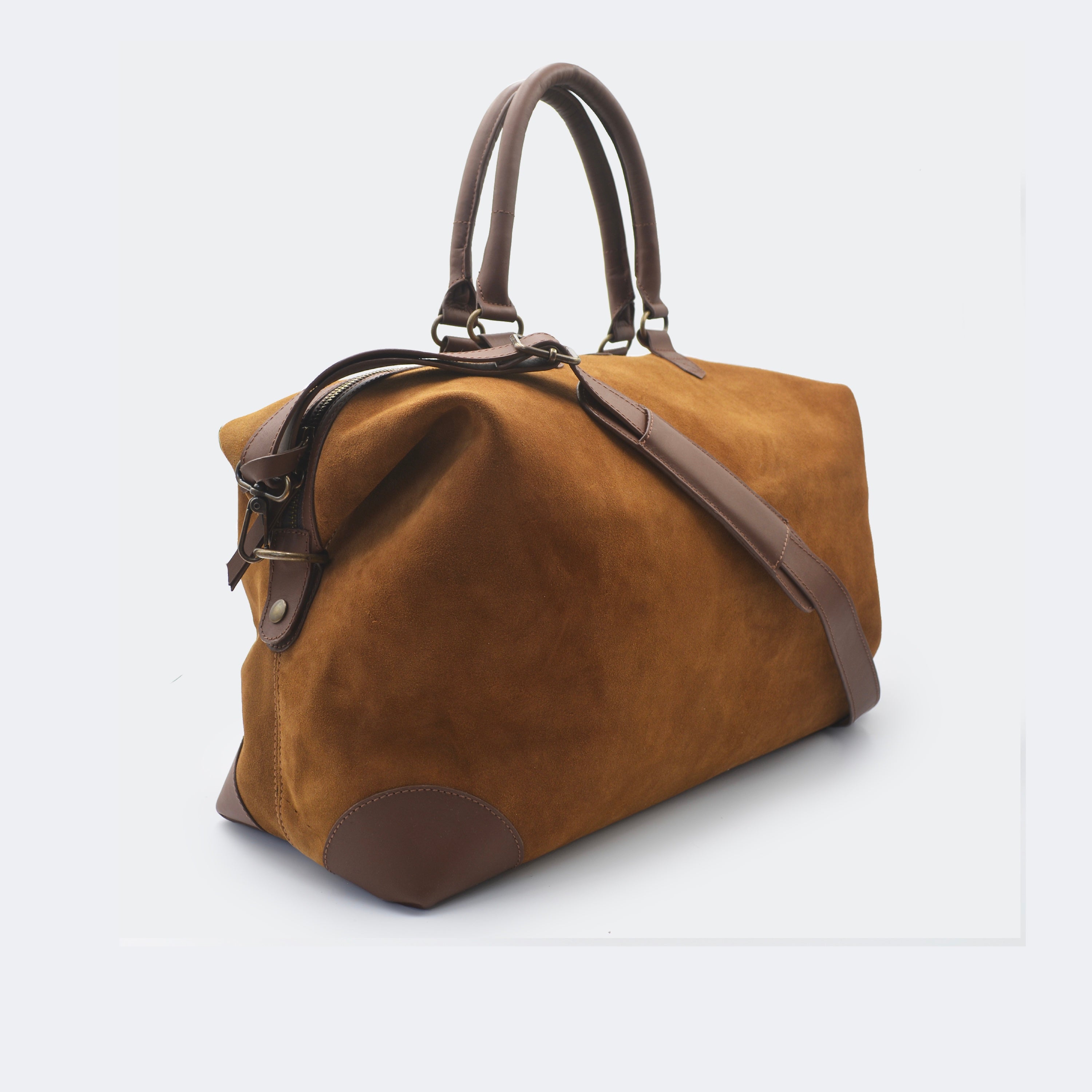 The Valise in brown leather, shown with its removable full-grain leather shoulder strap attached — designed for hands-free carry and versatile travel.