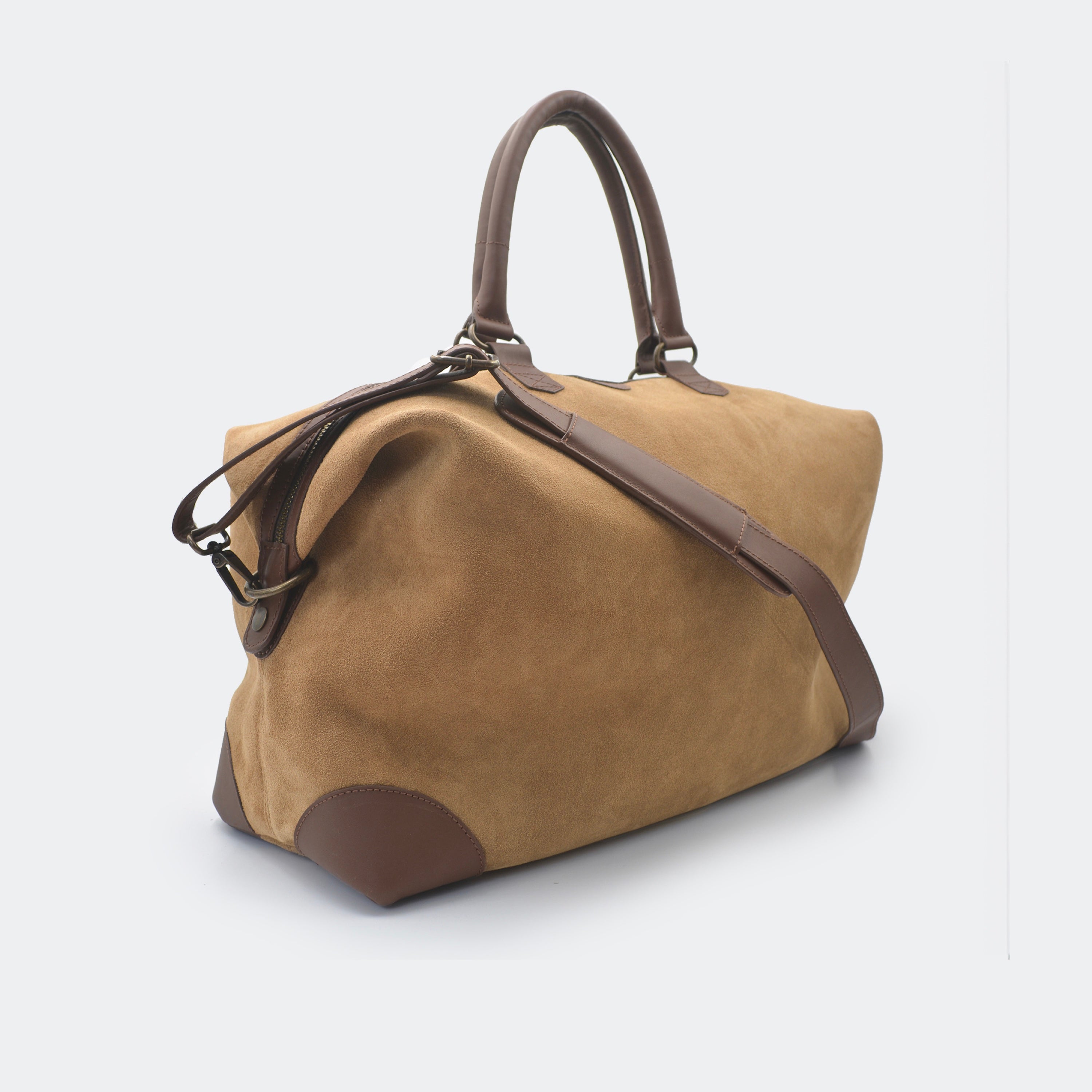 The Valise in brown leather, shown with its removable full-grain leather shoulder strap attached — designed for hands-free carry and versatile travel.