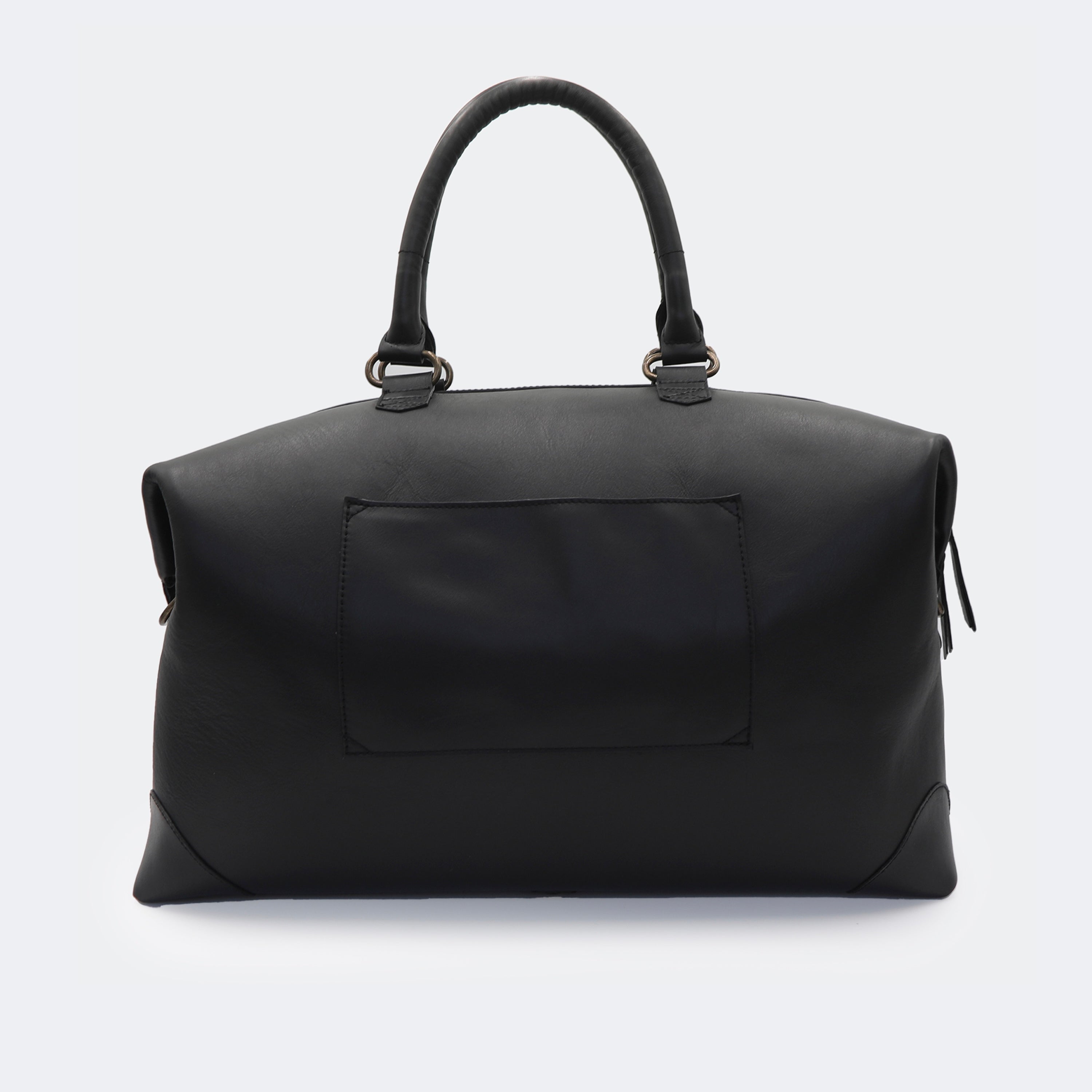 The Valise in black leather shown from behind, highlighting the integrated luggage band designed to slide over a suitcase handle.