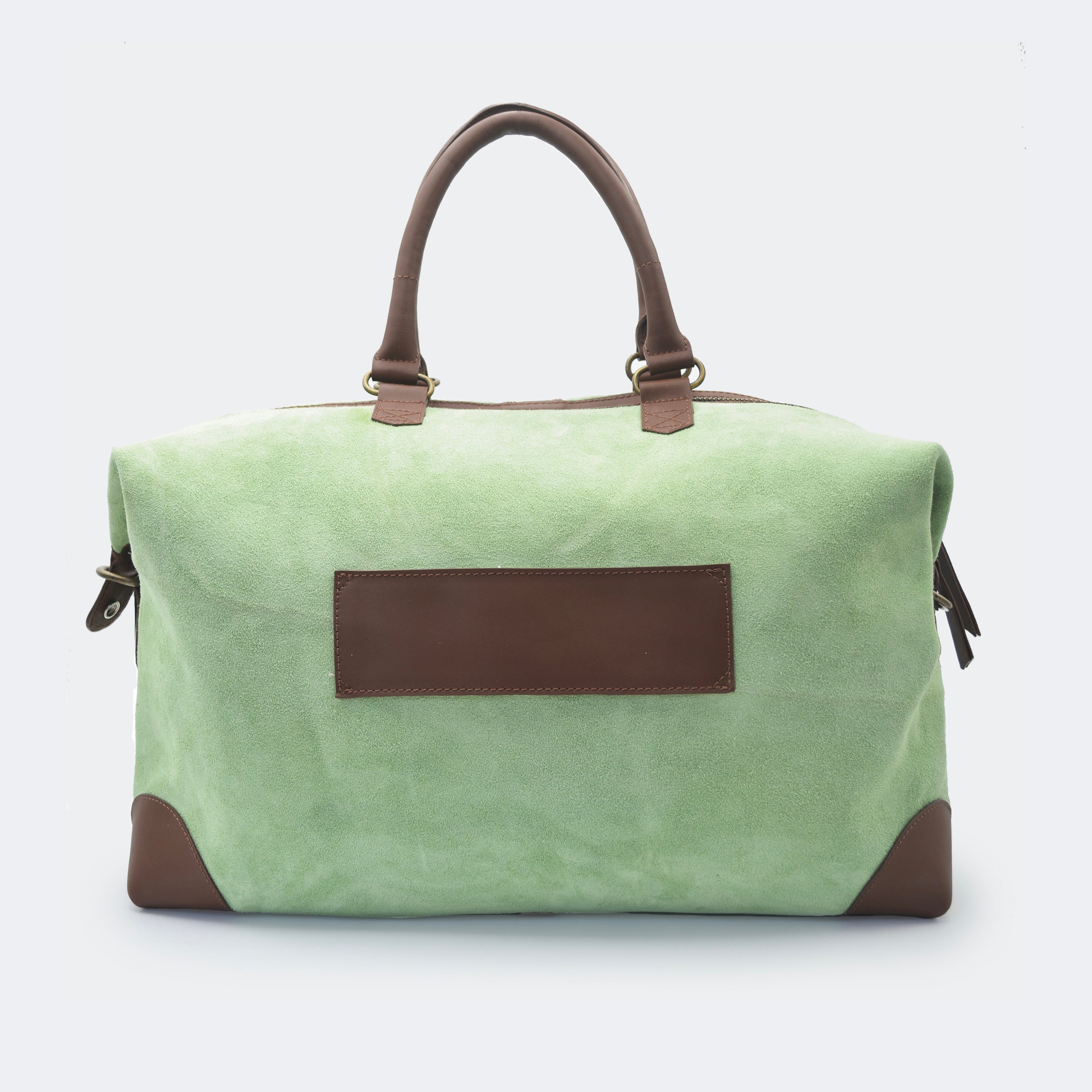The Valise in mint green leather shown from behind, highlighting the integrated luggage band designed to slide over a suitcase handle.